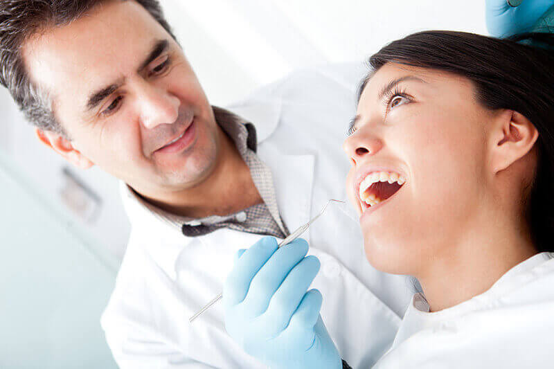 A dentist examining a patient.