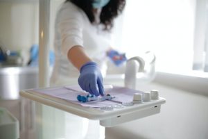 A dentist working in a lab coat.