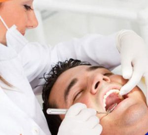 A dentist examining a patients mouth.