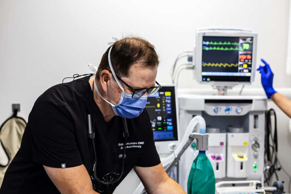 A doctor administering general anasthesia to a patient.