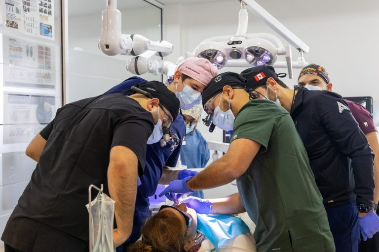 A photo of multiple dentists performing root canal anatomy affecting endodontic treatment outcomes.