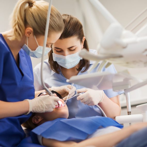 Female,Dentists,Treating,Patient,Girl,Teeth